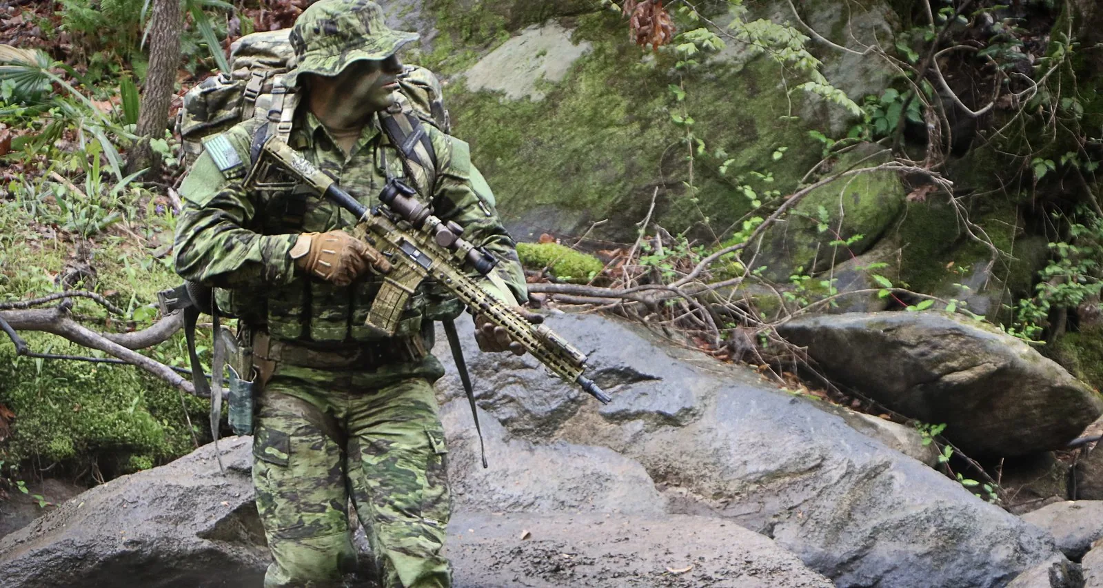 A-TACS FG-X operator crossing a wooded creek